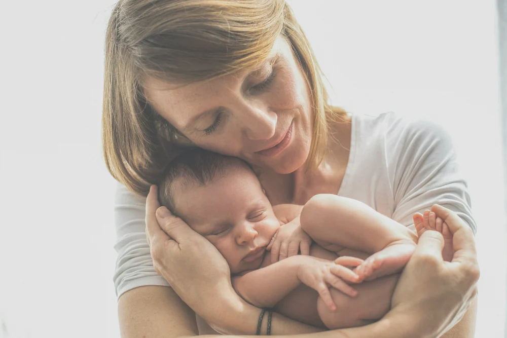 Bone Density After Breastfeeding: What New Moms Need to Know Bone density after breastfeeding: new mother nursing her baby while wondering about her bone health